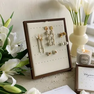 Vertical walnut wood earring display stand with white padded insert for elegant jewelry