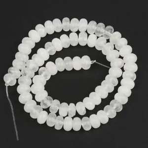 Macro view showing the translucent texture of 5x8mm natural white stone abacus beads