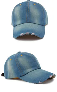 Detailed view of washed blue denim baseball cap featuring distressed brim and yellow stitching