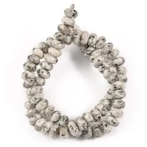 Macro view of 5x8mm natural stone dalmatian jasper abacus beads for DIY jewelry