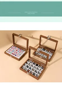 Detail of walnut grain jewelry boxes with glass lids showing internal compartments.