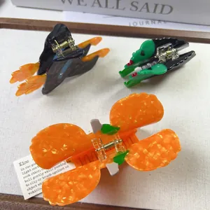 Festive Halloween acetate hair claw set featuring pumpkin and witch hat designs
