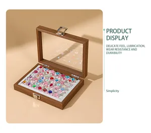 Close-up of walnut wood grain jewelry box with transparent lid and ring display