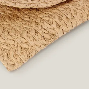 High-quality macro shot of the natural handwoven straw texture on a casual summer tote bag