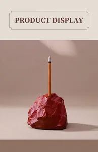Detailed view of a natural red ore stone incense burner with burning incense stick.