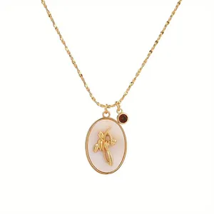 Detailed view of vintage gold oval necklace featuring mother-of-pearl flower pendant detail