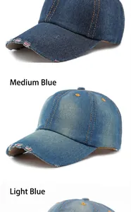 Detail view of washed denim baseball caps in medium and light blue with distressed finish.