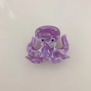 Macro detail of a cute purple marble acetate octopus animal hair claw clip for women