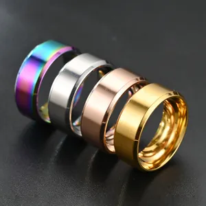 Macro detail of four titanium steel rings in gold, silver, rose gold, and rainbow finishes