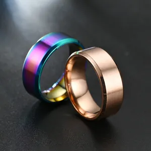Macro view of matte titanium steel rings showing rainbow and rose gold finishes.
