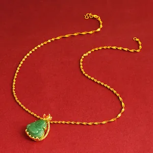 Elegant gold chain necklace featuring a green jade Buddha pendant on a red backdrop
