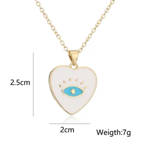 Close-up detail of 18K gold plated heart necklace with blue evil eye enamel pendant