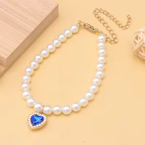 Detailed view of elegant pearl pet necklace with a blue heart-shaped rhinestone pendant.