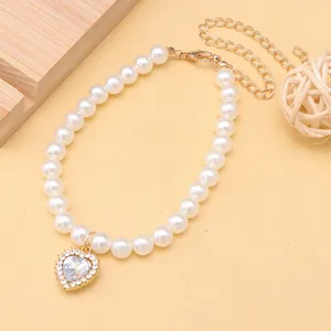 Elegant white pearl pet collar featuring a sparkling rhinestone heart pendant detail