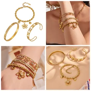 Close-up of gold stainless steel jewelry set featuring flower charms and zircon inlay