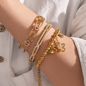 18K gold plated stainless steel bracelet set with zircon floral and D-link charms
