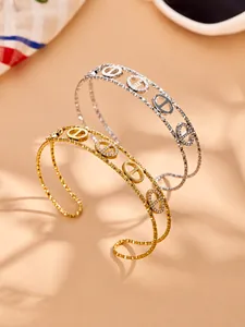 Close-up of gold and silver pig nose bangles with zircon pavé detail and textured bands