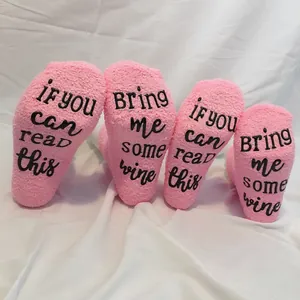 Comfortable pink fuzzy coral fleece socks with anti-slip 'Bring me wine' sole print
