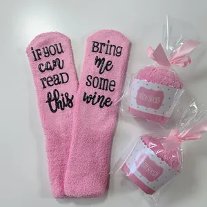 Cozy pink coral fleece wine socks with cupcake packaging and humorous text bring me some wine