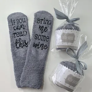 Close-up of gray coral fleece socks with cupcake-style gift packaging design detail