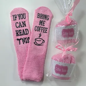 Pink coral fleece fuzzy socks with funny coffee text in creative cupcake packaging