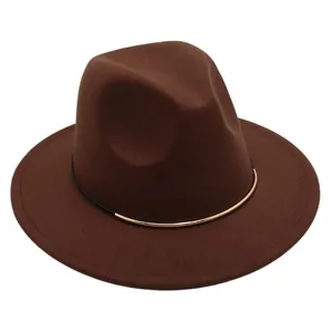 Close-up of brown wool felt jazz hat with stylish gold metal band decoration