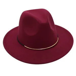 Detailed view of a burgundy wool felt fedora featuring an elegant black and gold band