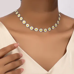 Close-up detail of a minimalist white daisy flower choker necklace worn on a model