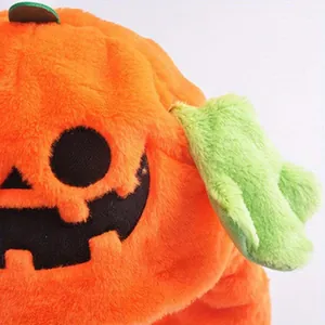 Detailed macro view of plush Halloween pumpkin hat featuring a soft orange jack-o'-lantern face