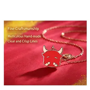 Detailed macro shot of a red enamel ox pendant necklace on luxurious red fabric