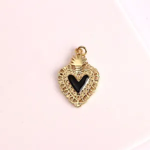 Close-up of retro gold heart pendant with black enamel center and intricate lace edge
