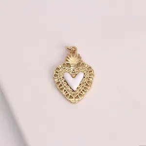 Detailed close-up of an elegant gold-tone heart pendant with a white enamel center