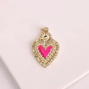 Detailed macro shot of vintage gold heart pendant with pink enamel heart