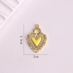 Retro gold heart pendant with yellow enamel center and intricate lace edge detail