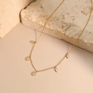 Detailed macro view of a gold-plated stainless steel necklace with marquise-cut stones