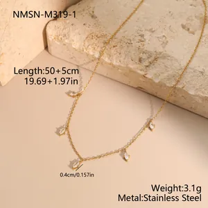 Macro view of gold stainless steel necklace with marquise-cut stone pendants and specs