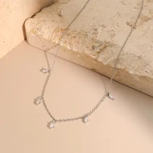 Silver stainless steel necklace with five marquise-cut white crystals on stone background