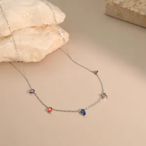 Close-up of minimalist stainless steel necklace with colorful multi-shape gemstones