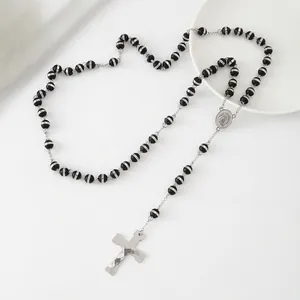 Minimalist stainless steel rosary necklace featuring black beads and a silver cross pendant