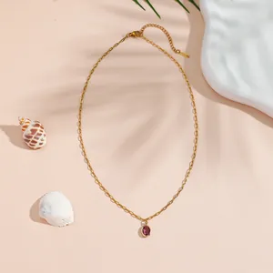 Elegant gold titanium steel necklace with an oval purple glass pendant for women.