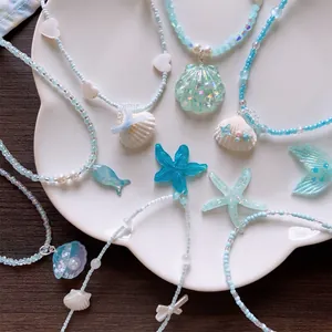 Handmade summer ocean themed beaded necklaces featuring seashell and starfish pendants