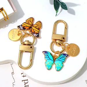 Set of colorful enamel butterfly keychains with gold 'Love' charms for bag decor