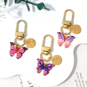 Set of colorful oil-drop butterfly pendant keychains with gold Love charms for bags
