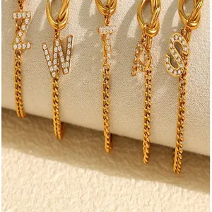 Close-up of gold-plated stainless steel letter pendants with sparkling rhinestones