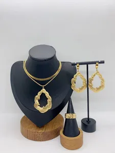 Detailed view of golden leaf texture jewelry set including necklace, earrings, and ring