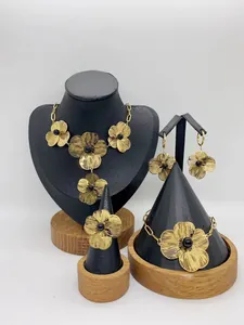 Elegant gold floral stainless steel jewelry set featuring necklace earrings bracelet and a ring