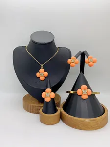 Complete orange four-leaf clover jewelry set with necklace, earrings, ring and bracelet