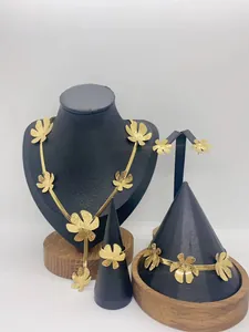 Detailed view of a gold-plated stainless steel jewelry set with elegant flower motifs