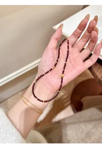 Detailed macro view of a natural garnet beaded bracelet with elegant gold accents.