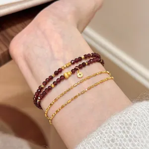 Elegant double-wrap natural garnet beaded bracelet with gold charms and stacked chains